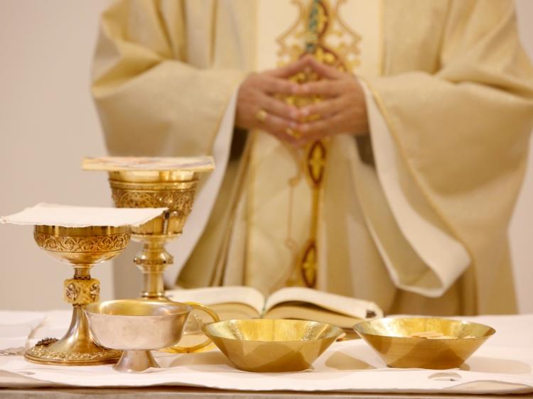 Ksiądz modlący się podczas Eucharystii